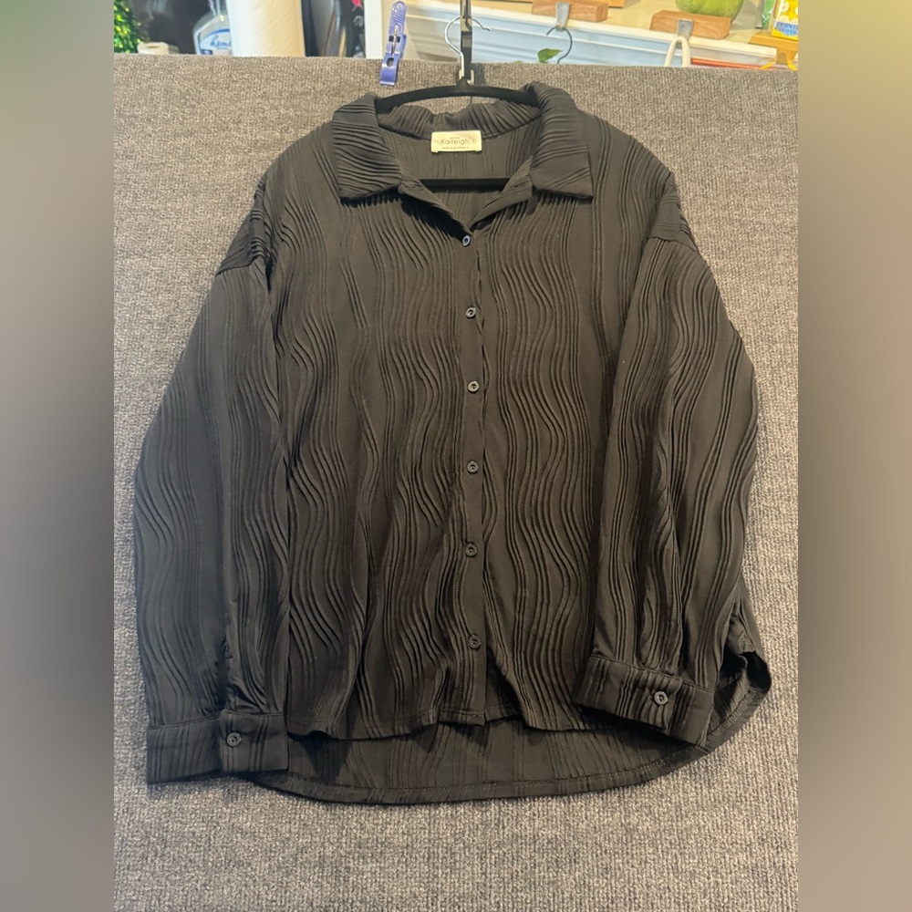 Beautiful black blouse, with raised wavy design.